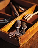 Old Wooden Spoons and Forks with Old Tools in a Wooden Box