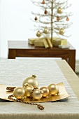 Golden Christmas tree baubles as table decoration