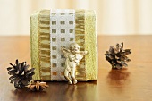 A Christmas present with a cherub, pine cones and star anise