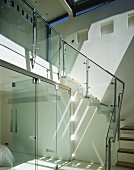Open stairway with sliding glass doors and steps with glass banister