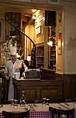 A chef standing in the reception of a restaurant