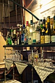 Various drinks in bottles and glasses in a bar