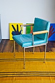 A light blue, vintage leather chair on a yellow rug