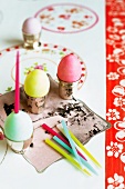 Colourful Easter eggs in silver egg cups