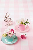 Easter decorations with lisianthus flowers in mocha cups and a silver bunny