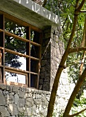Stone facade of house with modern lattice windows
