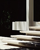 Concrete steps and white painted metal supports outside
