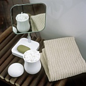 Cotton buds, soap, a make-up mirror and a towel