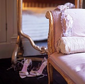 Women's underwear on an antique chair with a pink satin cover