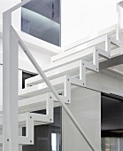 Zigzag steel profile and minimalistic handrail of light, white staircase
