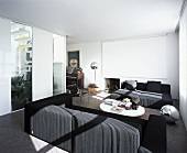 Light and shade on anthracite sofas in white, modern living room