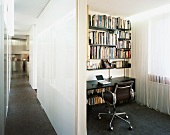 View of long hallway and small office niche with shelving and cord curtain