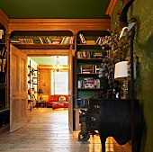 Traditional library with open door and view into salon
