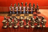 Chess pieces on board etched in glass