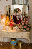 Vintage dressing table with floral arrangement and table lamps