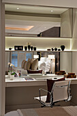 Desk with mirror and white shelves in the bedroom