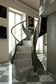 Modern spiral staircase with sculptural banister in marble look