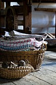 Basket of old objects in front of basket of laundry on floor