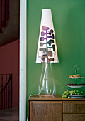 Table lamp with patterned shade on a wooden chest of drawers