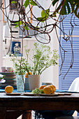 Table decoration with flower vases, crockery and lemons