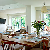 Dining room with wooden table, wooden chairs and view of the terrace