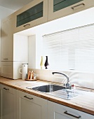 Detail of kitchen counter with closed window blinds