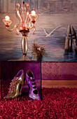 Venetian-style floor lamp and high heels in front of painted lagoon scenery