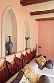 Bedroom with wall niches and textiles in warm colours