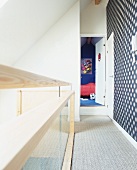 Modern gallery and open door to child's bedroom in attic