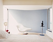 White minimalist bedroom with Bauhaus chaise longue