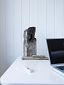 Detail of table with laptop and weathered pieces of wood