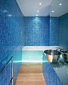 Bathroom with blue mosaic tiles and stainless steel sink