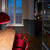Historic charm with pink lamps and coffee house chairs in London coffee bar