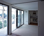View of balcony doors and kitchen from living room