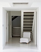 Quiet corner with armchair in hallway under stairs