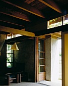 House with exposed wooden beam ceiling and concrete walls
