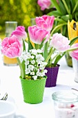 An arrangement of spring flowers featuring tulips on a laid table