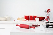 Red silicon rolling pin on white worktop