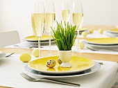 Table set for Easter with champagne flutes and eggs
