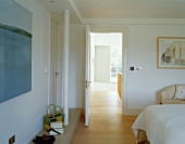 Modern bedroom with view of stairwell through open door