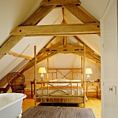 Four-poster bed with bamboo frame below open roof structure