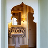 Doorway with Oriental pointed arch and view of vintage-style washstand