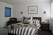 Bedroom with double bed, black and white bed linen and picture frame on the wall