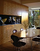 Dining area in front of wooden fitted cupboard with integrated aquarium