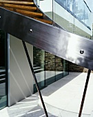 Stainless steel stringer on curved staircase in courtyard of contemporary house