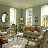 Classic living room with pastel green walls and antique furniture