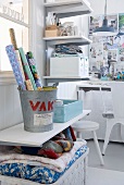 Practical shelving and baskets keeping white, shabby-chic workroom tidy