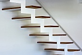 Detail of structure of modern designer staircase with zigzag framework and wooden treads