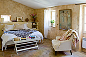 Country-style bedroom with rustic walls and natural stone floor