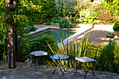 Seating area with a view of the swimming pond and garden plants